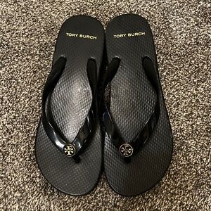 Tory Burch Black Flip Flops with Gold Logo Accent